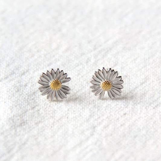 sterling silver daisy earrings with colored enamel. post closure.
